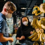 travelers buying bananas